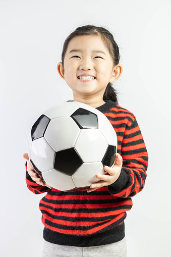 Little Girl Holding a Football