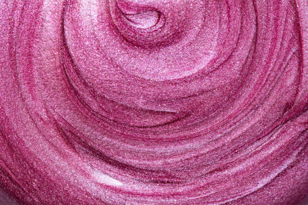 istock Texture of lip gloss. Smudged makeup product sample. Sparkling background 1208477342