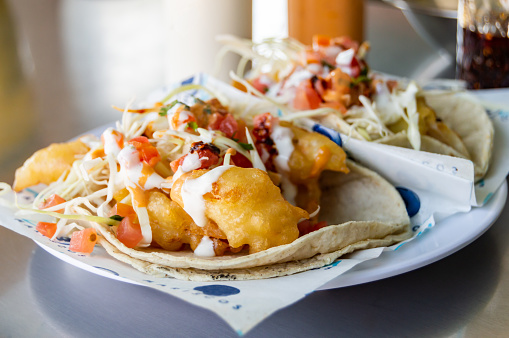 Fish and shrimp tacos, Baja California style seafood tacos served with cabbage,tomatoes,cilantro and a variety of salsas