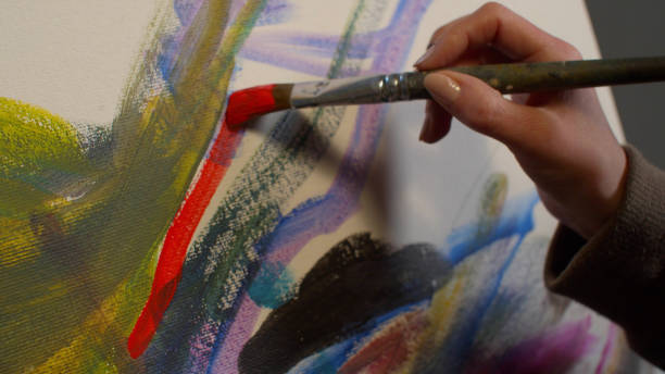 istock Woman draws a picture with paints, close up 1208479241