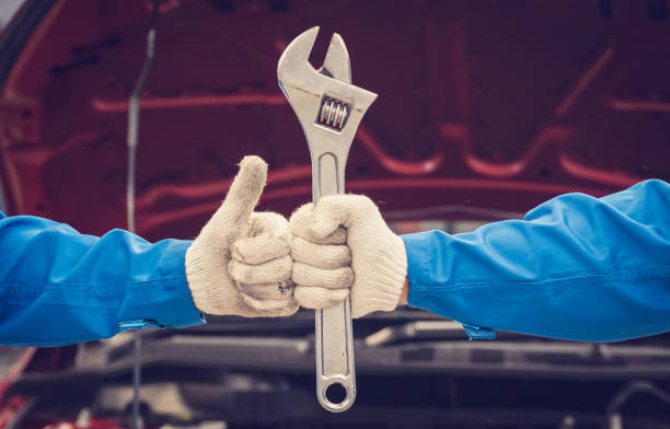 istock Mechanics holding wrench and tagging his friend's hand. Team work concepts 1208481124