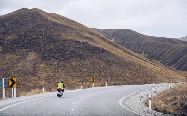 Photo of A motorcycle drive on the road of Lindis pass nearly Queenstown, New Zealand.