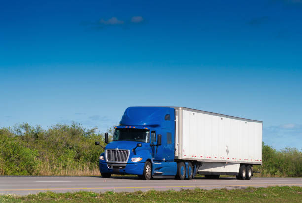 istock Red truck with container on the road Florida 1208485157