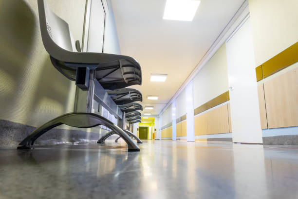 istock Long corridor in hospital with chairs 1208495723