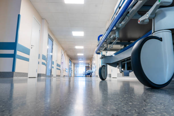 Medical bed on wheels in the hospital corridor. Medical bed on wheels in the hospital corridor. View from below. hospital stock pictures, royalty-free photos & images