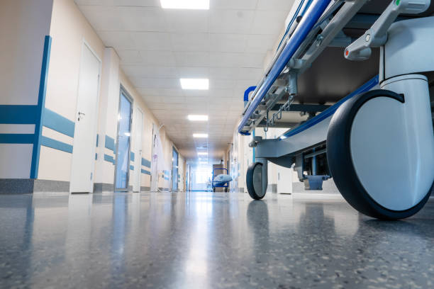 Medical bed on wheels in the hospital corridor. Medical bed on wheels in the hospital corridor. View from below. hospital emergency sign stock pictures, royalty-free photos & images