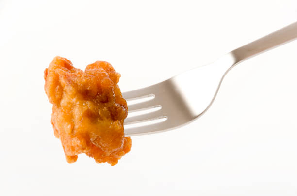 istock Japanese food, tori karaage, Fried chicken on a fork on white background 1208495921