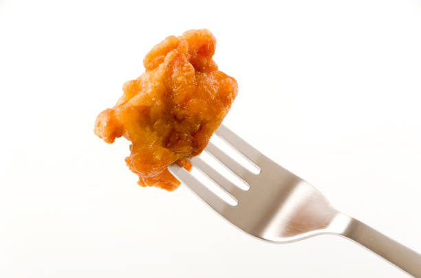 istock Japanese food, tori karaage, Fried chicken on a fork on white background 1208496470