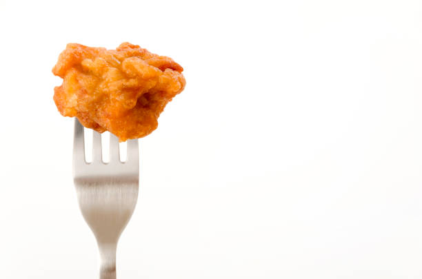 Japanese food, tori karaage, Fried chicken on a fork on white background