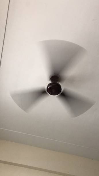 istock Image of spinning ceiling fan, viewed from below 1208496690