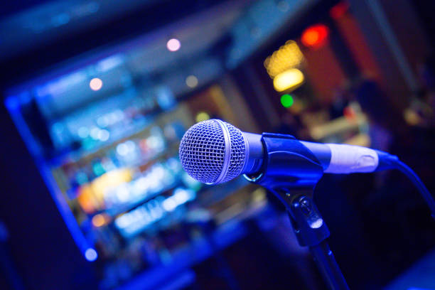 istock Comedy or Music Show at Night with Microphone and Blue Lights Nightlife 1208497407