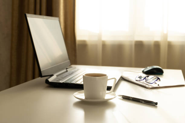 istock Home office. Workplace with a laptop for freelancing. Morning coffee before work. Monochrome. 1208498529