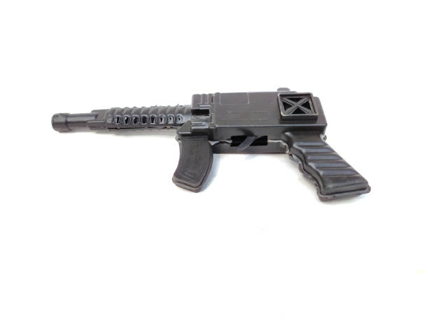 istock a black plastic toy gun isolated on white background 1208498578