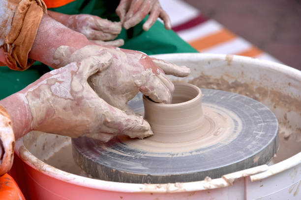 istock A human Potter works on a Potter's wheel, making a ceramic pot from clay in a pottery workshop. 1208502591