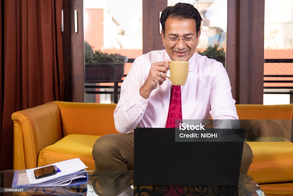 Businessman having coffee Businessman working at home , sipping coffee , happy positive work Coffee - Drink Stock Photo