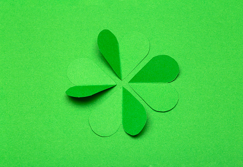 St. Patrick 's Day (St. Paddyâs Day) background concept. Green clover from paper on a green background. Clover is a symbol of Ireland and Celtic culture.