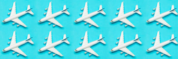 istock Travel minimal background banner. Model airplane in flight on an empty colored background. Copy space 1208507752