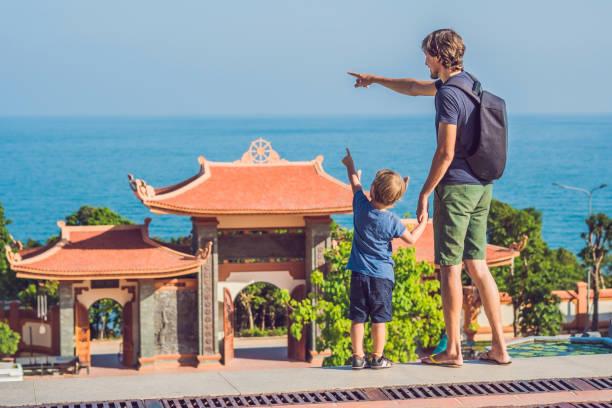 Happy tourists dad and son in Pagoda. Travel to Asia concept. Traveling with a baby concept stock photo