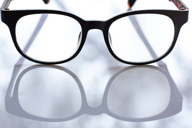 istock Black shortsighted or nearsighted eyeglasses on white acrylic table background, Close up & Macro shot, Selective focus, Reflection, Optical concept 1208509517