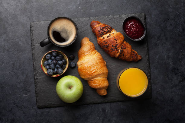 istock Breakfast with coffee and croissant 1208509743