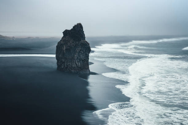 Black Beach Dramatic black-sand beach Reynisfjara on Iceland. rock formation photos stock pictures, royalty-free photos & images