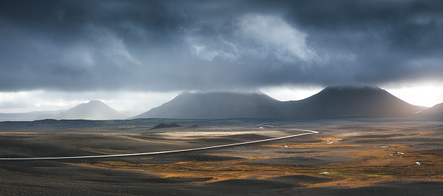 Illuminated road in dramatic volcanic landscape in Iceland.