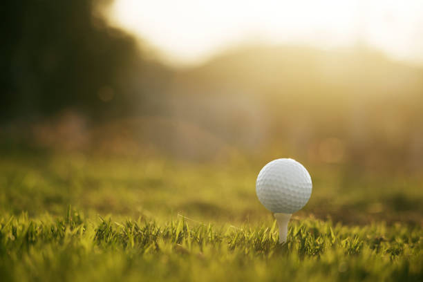 istock golf ball on tee in a beautiful golf course 1208513031