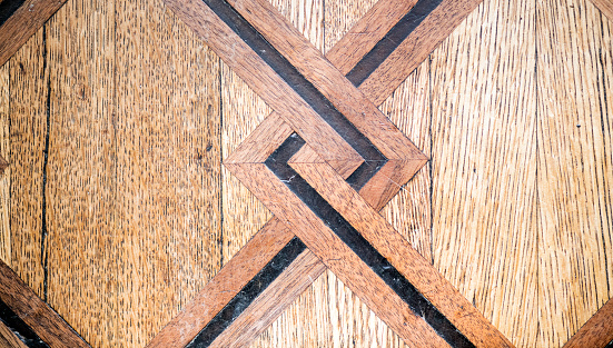 Ornate wooden inlay detail on old floor