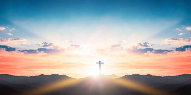 istock Silhouette cross on mountain sunset background 1208518016