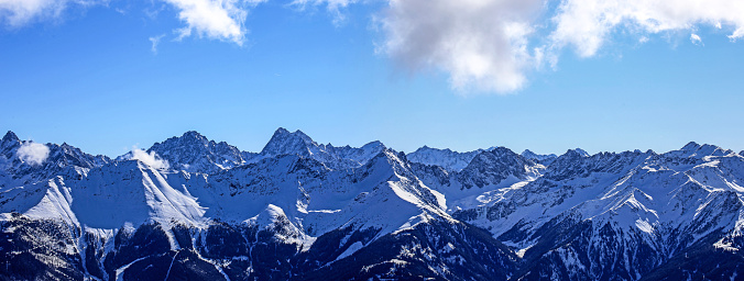 Alpine panorama with snow-covered mountain peaks in winter