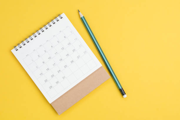 istock White clean calendar on solid yellow background with pencil and copy space, business meeting planning, travel schedule or project milestone and reminder concept 1208520234
