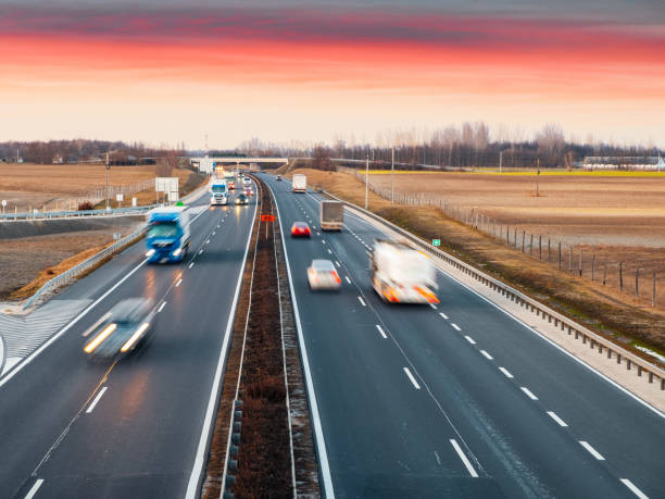 istock Busy highway with fast moving vehicles in beautiful sunset 1208520296