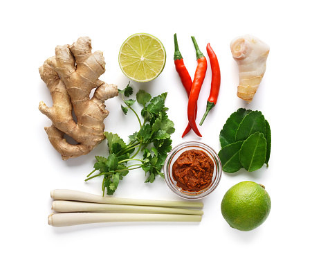 Set of Tom Yum soup basic ingredients - lemon grass, chilli peppers, galanga root, ginger, Tom Yam paste and kaffir lime leaves. Isolated on white.