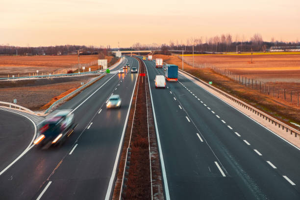 istock Busy highway with fast moving vehicles in beautiful sunset 1208520501
