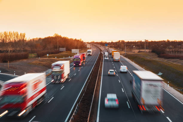 istock Busy highway with fast moving vehicles in beautiful sunset 1208521056