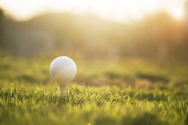 istock golf ball on tee in a beautiful golf course 1208521100