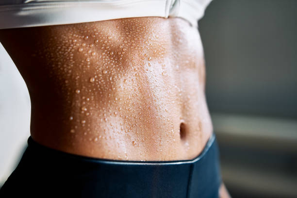 close up of fit woman torso with sweat on skin after workout - beautiful one person strength sensuality imagens e fotografias de stock