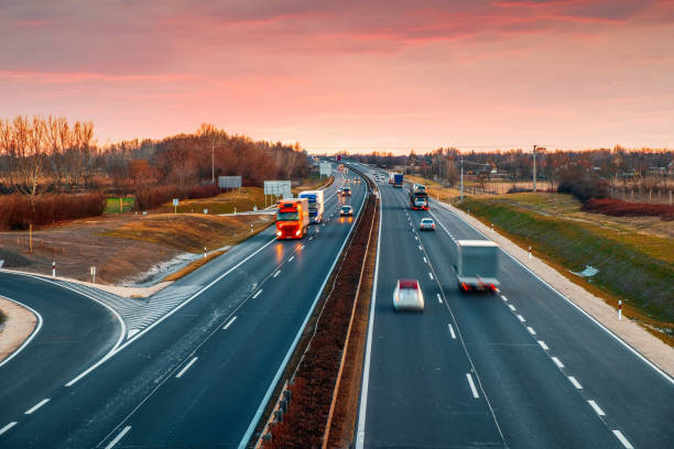 istock Busy highway with fast moving vehicles in beautiful sunset 1208521151