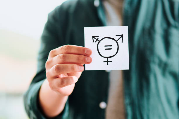 Equality stems progress for all Cropped shot of unrecognizable man holding a piece of paper with gender equality symbols indoors gender symbol stock pictures, royalty-free photos & images