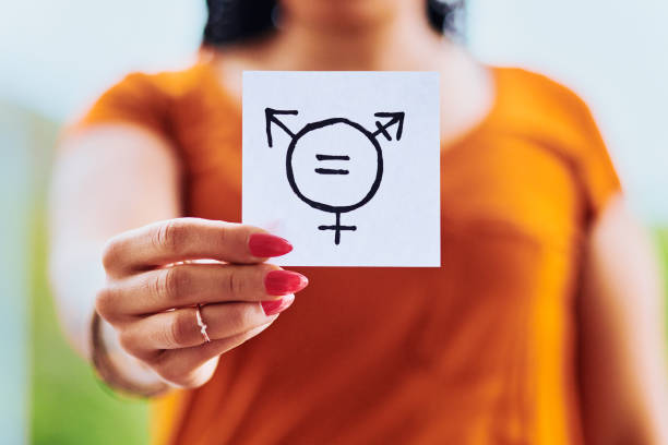 Every gender should be treated equally Cropped shot of unrecognizable woman holding a piece of paper with gender equality symbols outdoors gender fluid photos stock pictures, royalty-free photos & images