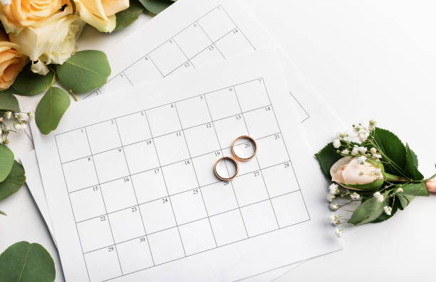 istock Planning wedding date in calendar, gold rings 1208521934