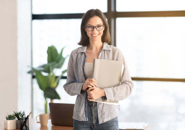 istock Happy manager smiling at camera in modern office 1208521951