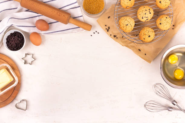 Culinary equipment and ingredients. Eggs, flour, sugar, chocolate, butter, bakeware. Flat lay. Copy space.