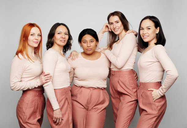 istock Portrait of attractive Multi-ethnic women without makeup embracing while posing against white background 1208523356