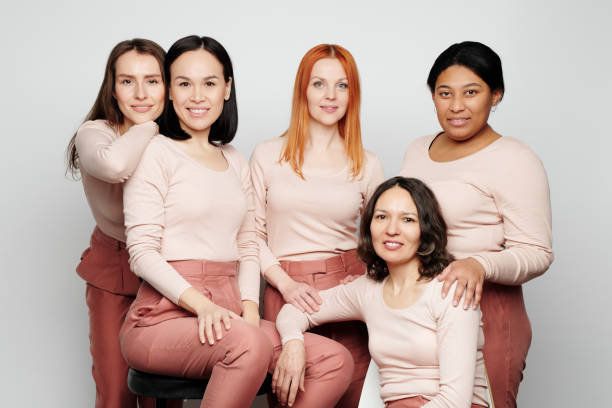 istock Group of bright and confident multi-ethnic ladies in same outfit posing together against isolated background 1208523519