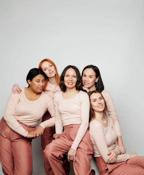 istock Group of smiling bright multi-ethnic women in same clothes looking at camera, variety of womens beauty concept 1208523532