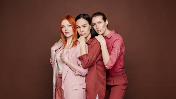 istock Diverse young multi-ethnic women standing one after another against brown background 1208524646