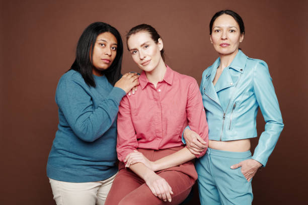 istock Group of content attractive multi-ethnic women in different clothes posing together against isolated background 1208524650