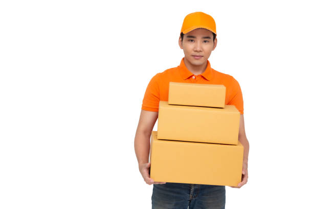 istock Delivery man courier holding parcel box package isolated on white background. Deliver and shipment concept 1208525098