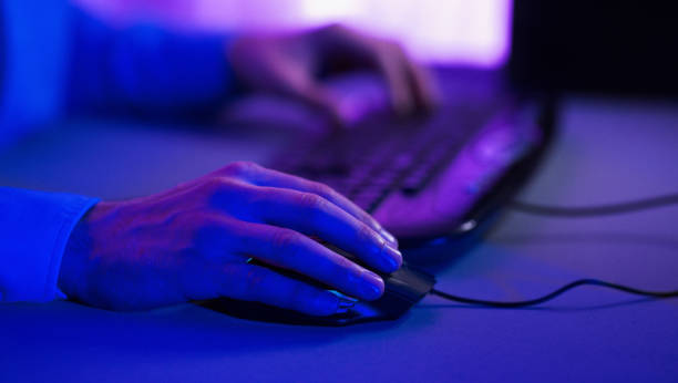 istock Unrecognizable Gamer Using Mouse Playing Computer Game Indoor, Cropped, Closeup 1208525170